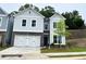 Charming two-story home with stone accents, white garage door and a well-manicured lawn at 360 Lakeside Ct, Canton, GA 30114