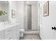 Modern bathroom features tile floor, glass shower with a herringbone tile accent wall, and white vanity at 3317 Stillwood Ln, Hapeville, GA 30354