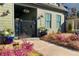 Charming home exterior with manicured garden featuring a variety of colorful plants and a gate entrance at 3317 Stillwood Ln, Hapeville, GA 30354