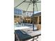 Community pool area offers a serene escape with comfortable lounge chairs and engaging tic-tac-toe table under a cooling umbrella at 3317 Stillwood Ln, Hapeville, GA 30354