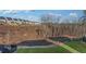Sloping backyard with distant homes, wooded area, grass, and erosion control fabrics at 3025 Sunset Pass, Canton, GA 30114
