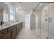 Large bathroom with double vanity, a large glass shower, and a view from the window at 3025 Sunset Pass, Canton, GA 30114
