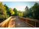 A scenic view of a wooden boardwalk surrounded by lush greenery and natural beauty at 3025 Sunset Pass, Canton, GA 30114