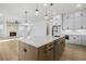 Open kitchen featuring an island with seating, modern fixtures, and views of the fireplace and living area at 3025 Sunset Pass, Canton, GA 30114