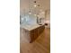Open kitchen with a large island, modern pendant lighting, and views of the living area with a fireplace at 3025 Sunset Pass, Canton, GA 30114