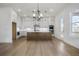 Spacious kitchen with stainless steel appliances, a large island, white cabinets, and modern lighting fixtures at 3025 Sunset Pass, Canton, GA 30114