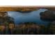 Lake view surrounded by thick wooded forests with vibrant fall colors at 3025 Sunset Pass, Canton, GA 30114