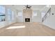 Bright living room featuring a brick fireplace, many windows, and staircase at 3025 Sunset Pass, Canton, GA 30114