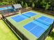 Well-maintained pickleball courts surrounded by a fence and lush green grass at 3025 Sunset Pass, Canton, GA 30114