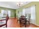 Bright dining room features hardwood floors and a charming table set at 1123 Diamond Xing, Mcdonough, GA 30252