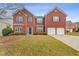 Brick two-story house with a two-car garage and landscaping at 1123 Diamond Xing, Mcdonough, GA 30252