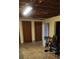 Unfinished basement features exposed ceiling with two wooden doors at 358 Gold Mine Rd, Dallas, GA 30157
