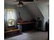 Bedroom features a window air conditioner, guitar, and converted desk space at 358 Gold Mine Rd, Dallas, GA 30157