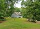 Exterior view of home featuring wooded surroundings and a covered front porch at 358 Gold Mine Rd, Dallas, GA 30157