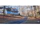 Charming two-story home with a covered front porch and a long driveway through a wooded landscape at 358 Gold Mine Rd, Dallas, GA 30157