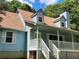 A cozy home exterior shows a welcoming front porch with a white railing and steps leading to the entrance at 358 Gold Mine Rd, Dallas, GA 30157