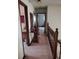 Second story hallway with wood railings and neutral tones, connecting the home's bedrooms at 358 Gold Mine Rd, Dallas, GA 30157