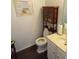 Small bathroom with a toilet, sink, and storage cabinet at 1671 Nations Trl, Riverdale, GA 30296