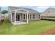View of the backyard, showcasing the patio, well-maintained lawn, and exterior details of the home at 128 Laurel Farms Ln, Dallas, GA 30157