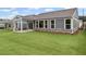 Expansive backyard with green lawn and view of the home's exterior with a covered patio at 128 Laurel Farms Ln, Dallas, GA 30157