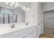Double sink bathroom with stone countertops and walk-in closet access at 128 Laurel Farms Ln, Dallas, GA 30157