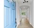 Inviting entryway with light blue front door, light walls, and hardwood floors throughout at 128 Laurel Farms Ln, Dallas, GA 30157