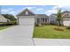 Charming one-story home featuring gray siding, manicured lawn, and a two-car garage at 128 Laurel Farms Ln, Dallas, GA 30157