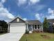 Charming single-story home with a two-car garage, manicured lawn, and welcoming front entrance at 128 Laurel Farms Ln, Dallas, GA 30157