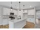 Beautiful kitchen with white cabinets, hardwood floors, stainless appliances, and an island with granite countertop at 128 Laurel Farms Ln, Dallas, GA 30157