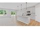 Modern kitchen with white cabinets, hardwood floors, stainless appliances, and granite countertops at 128 Laurel Farms Ln, Dallas, GA 30157
