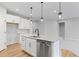 Modern kitchen featuring an island with stainless dishwasher, and hardwood floors at 128 Laurel Farms Ln, Dallas, GA 30157