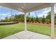 Covered patio overlooking a beautifully landscaped backyard with privacy trees and a fence at 128 Laurel Farms Ln, Dallas, GA 30157