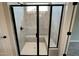 New shower with glass doors, a built-in seat, and grey tile at 128 Laurel Farms Ln, Dallas, GA 30157