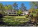 Spacious backyard offers mature trees, blossoming shrubs, and outdoor seating, perfect for relaxation and entertainment at 111 Mount Vernon Dr, Decatur, GA 30030