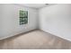 Cozy bedroom with neutral carpet and a window providing natural light at 2713 Laurel View Dr, Snellville, GA 30039