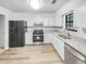 Modern kitchen featuring white cabinets, stainless steel appliances, and granite countertops at 2713 Laurel View Dr, Snellville, GA 30039
