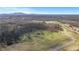An aerial view of community green space, mature trees, and mountain views from future homesites at 6670 Benchwood Path, Cumming, GA 30028