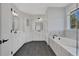 Elegant bathroom with a soaking tub, double vanity, and tile flooring at 6670 Benchwood Path, Cumming, GA 30028