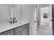 Modern bathroom featuring gray cabinetry, brushed gold hardware and quartz countertop at 6670 Benchwood Path, Cumming, GA 30028