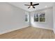 Bright bedroom with a modern ceiling fan, two windows, and light-colored flooring at 6670 Benchwood Path, Cumming, GA 30028