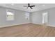 Bedroom with hardwood flooring, tray ceiling and two windows offering natural light at 6670 Benchwood Path, Cumming, GA 30028