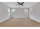 Bright and airy bedroom with hardwood floors, neutral walls, and modern ceiling fan at 6670 Benchwood Path, Cumming, GA 30028