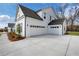 A modern home with a concrete driveway, a two car garage and professional landscaping at 6670 Benchwood Path, Cumming, GA 30028