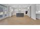 Spacious white kitchen with gray island, stainless appliances, white cabinets and tile backsplash at 6670 Benchwood Path, Cumming, GA 30028