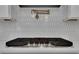 A Frigidaire Gallery cooktop is featured with a pot filler and white tile backsplash at 6670 Benchwood Path, Cumming, GA 30028