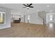Open-concept living space with stairway and view of white kitchen with gray island at 6670 Benchwood Path, Cumming, GA 30028