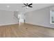 Open-concept living space featuring hardwood floors and stairway to second level at 6670 Benchwood Path, Cumming, GA 30028