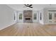 Bright living room featuring a stone fireplace, large windows, and hardwood floors at 6670 Benchwood Path, Cumming, GA 30028