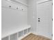 Mudroom features built-in bench with storage cubbies, hooks, and a door to exterior at 6670 Benchwood Path, Cumming, GA 30028