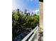 Balcony view shows the city skyline beyond trees, offering an urban oasis at 171 Auburn Ave # 329, Atlanta, GA 30303